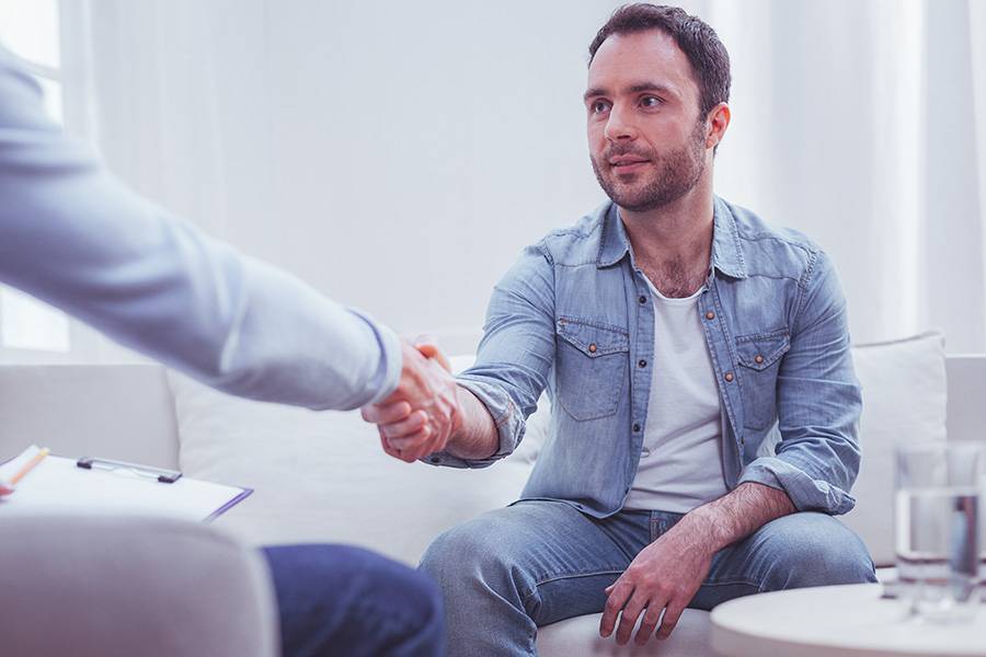 Satisfied man expressing gratitude to his personal psychiatrist
